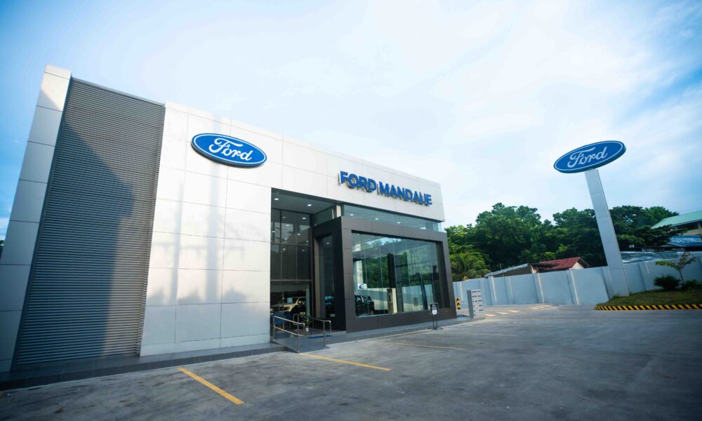 Exterior view of the newly opened Ford Mandaue dealership in Cebu, featuring a modern building facade with Ford signage and a spacious parking area.
