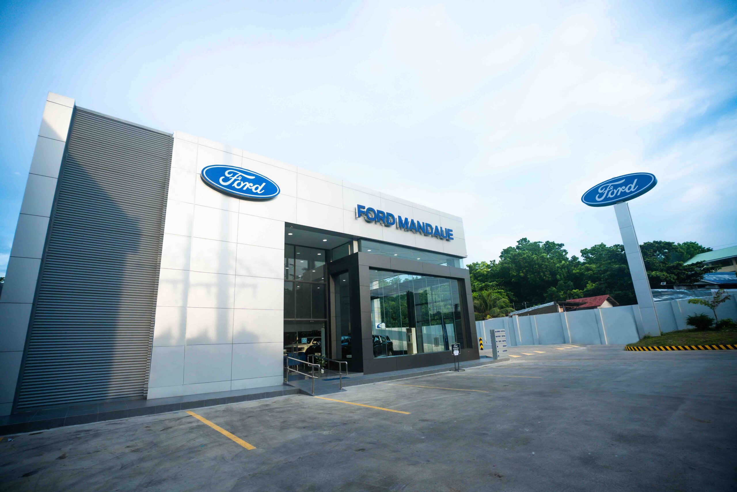 Exterior view of the newly opened Ford Mandaue dealership in Cebu, featuring a modern building facade with Ford signage and a spacious parking area.