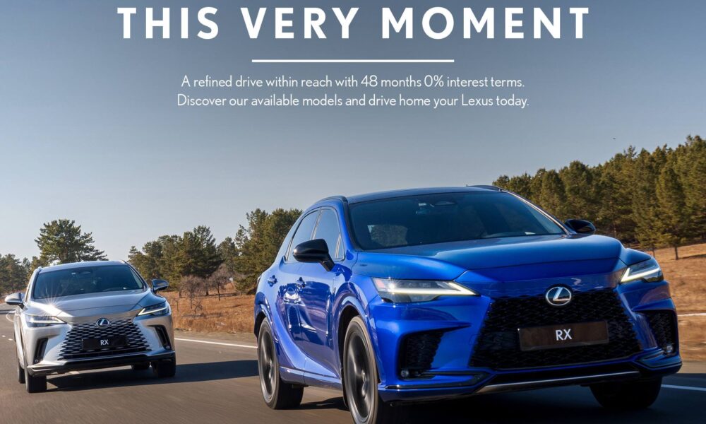 Two Lexus RX SUVs, one in vibrant blue and the other in silver, drive side by side on a scenic road flanked by trees under a clear blue sky. Promotional text reads: “Drive Elegance This Very Moment – A refined drive within reach with 48 months 0% interest terms.” The image promotes Lexus Philippines' special financing offer running until June 30, 2025.
