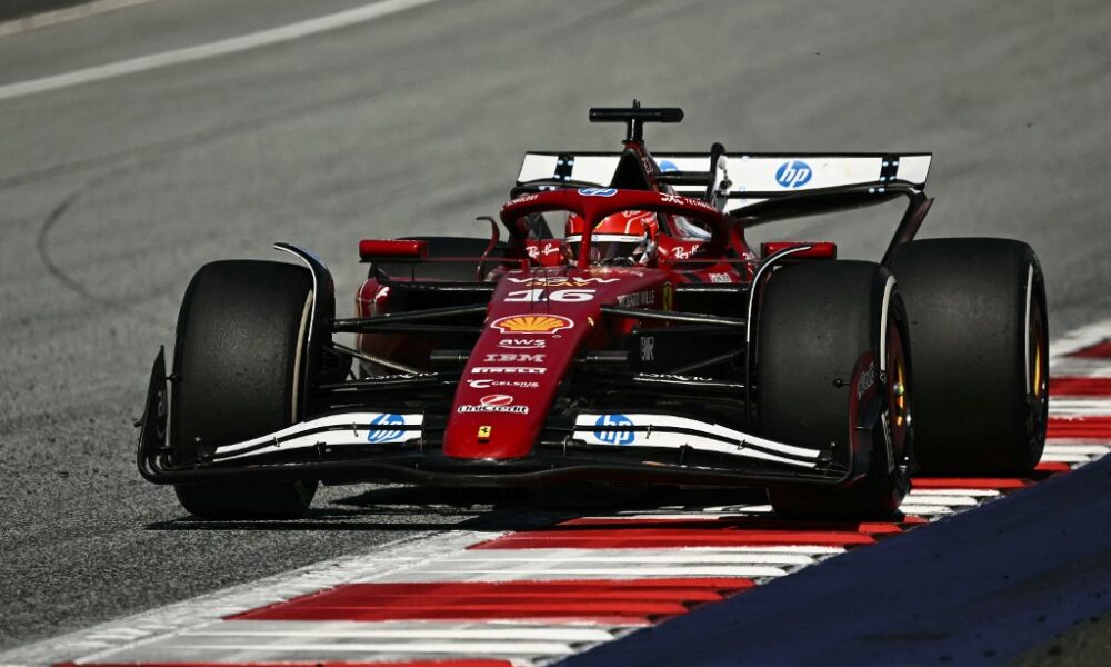 Ferrari Formula 1 driver Charles Leclerc powers through a corner at the Red Bull Ring during the 2025 Austrian Grand Prix, with his red SF-24 car riding the curb under bright track conditions.