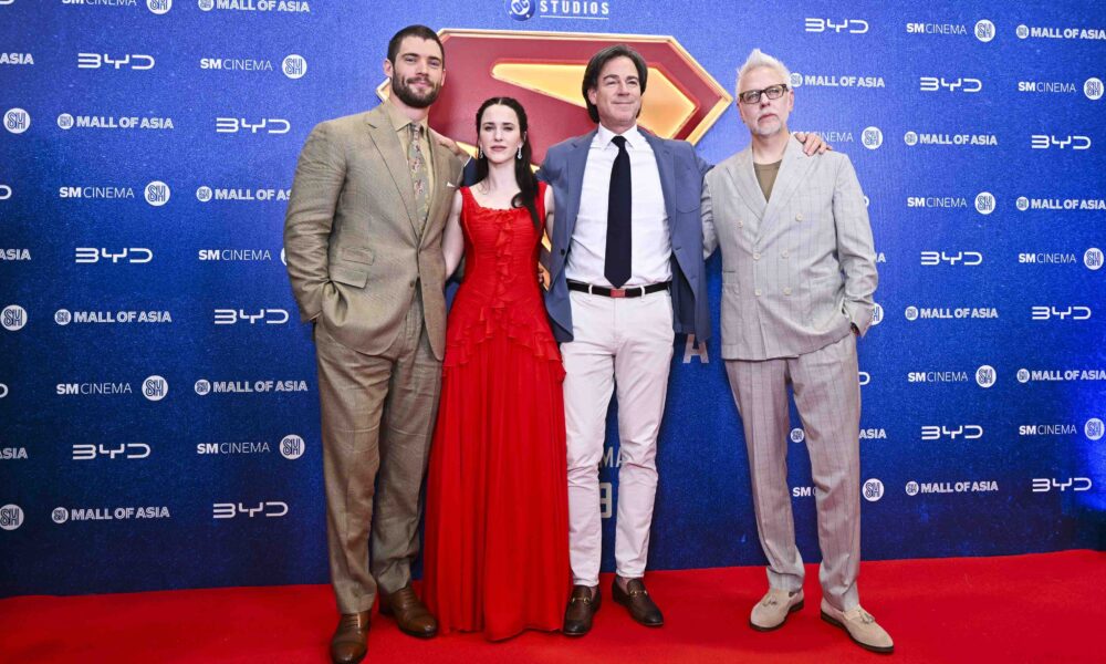 The cast and crew of the Superman movie pose on the red carpet at the SM Mall of Asia Music Hall during the film’s Philippine fan event. They stand in front of a backdrop with BYD, SM Cinema, and DC Studios logos.