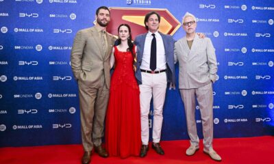 The cast and crew of the Superman movie pose on the red carpet at the SM Mall of Asia Music Hall during the film’s Philippine fan event. They stand in front of a backdrop with BYD, SM Cinema, and DC Studios logos.