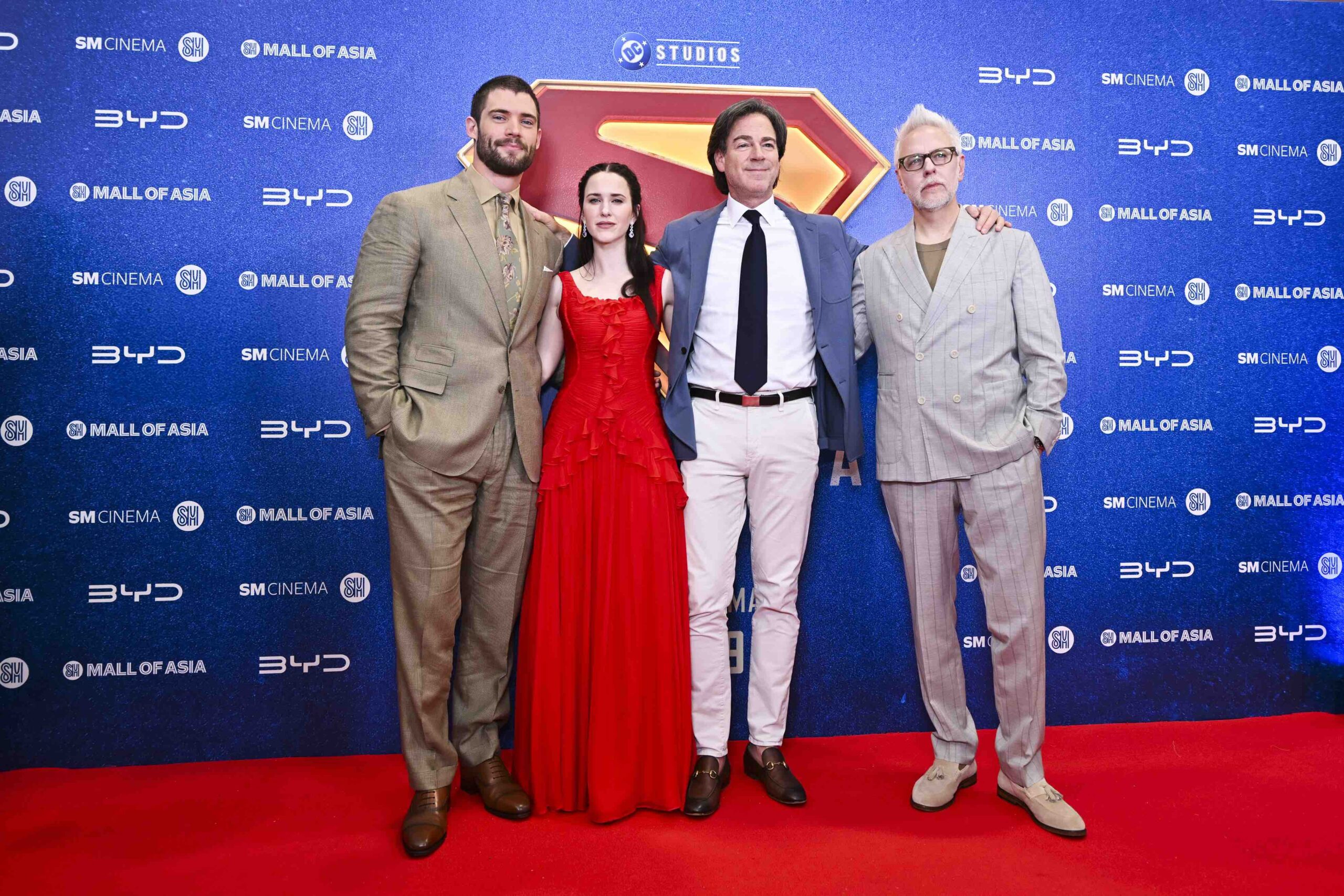 The cast and crew of the Superman movie pose on the red carpet at the SM Mall of Asia Music Hall during the film’s Philippine fan event. They stand in front of a backdrop with BYD, SM Cinema, and DC Studios logos.
