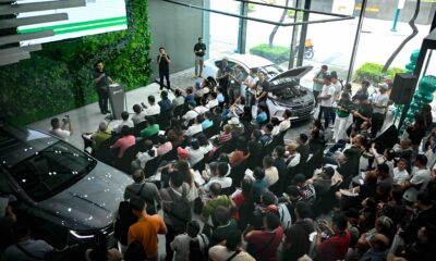 A crowd of GrabCar drivers attends a presentation during the BYD Grab Day Caravan at BYD Global City, with a BYD Seal 5 DM-i on display.