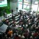 A crowd of GrabCar drivers attends a presentation during the BYD Grab Day Caravan at BYD Global City, with a BYD Seal 5 DM-i on display.