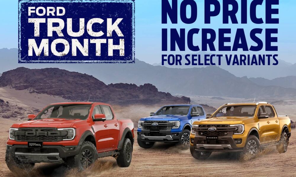 Three Ford Ranger pickup trucks — in red, blue, and orange — drive across a desert landscape beneath a bright blue sky. A large banner reads “Ford Truck Month” on the left, with the text “No Price Increase for Select Variants” on the right.