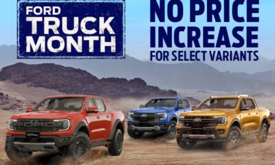 Three Ford Ranger pickup trucks — in red, blue, and orange — drive across a desert landscape beneath a bright blue sky. A large banner reads “Ford Truck Month” on the left, with the text “No Price Increase for Select Variants” on the right.