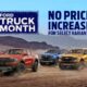 Three Ford Ranger pickup trucks — in red, blue, and orange — drive across a desert landscape beneath a bright blue sky. A large banner reads “Ford Truck Month” on the left, with the text “No Price Increase for Select Variants” on the right.