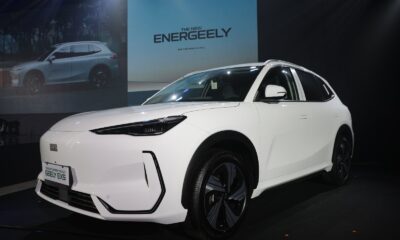 Front-side view of the all-electric Geely EX5 on stage at its Philippine launch event, under dramatic lighting with “ENERGEELY” graphics in the background.