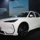 Front-side view of the all-electric Geely EX5 on stage at its Philippine launch event, under dramatic lighting with “ENERGEELY” graphics in the background.