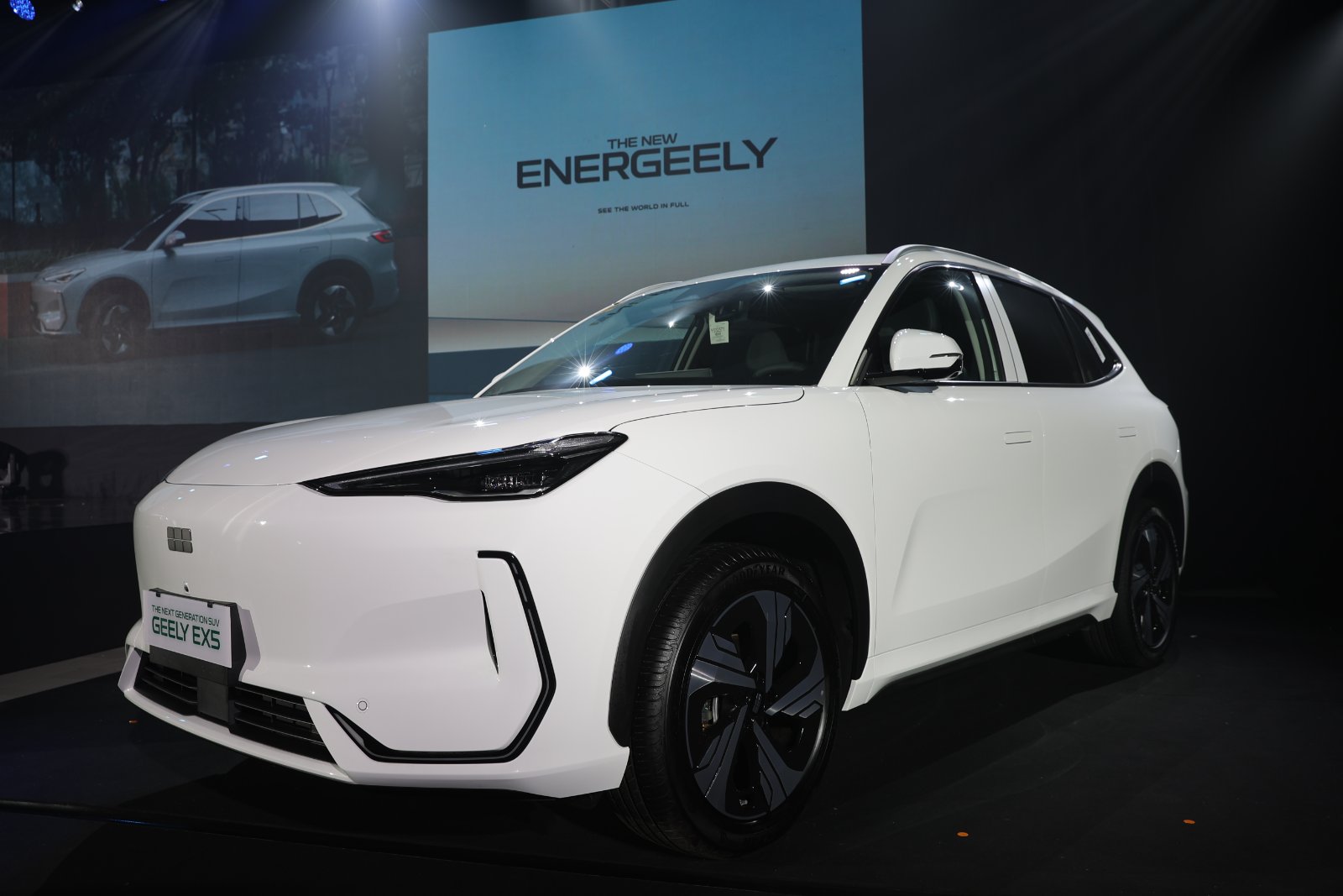 Front-side view of the all-electric Geely EX5 on stage at its Philippine launch event, under dramatic lighting with “ENERGEELY” graphics in the background.