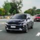 A convoy of Kia Sonet SUVs cruises along a highway, led by a black unit followed by red and white Sonets, during the Kia Sonet Pilipinas Club’s grand meet in Nuvali.