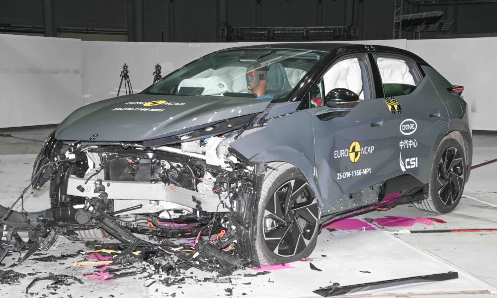 Frontal crash test of a Lynk & Co 02 electric SUV conducted by Euro NCAP, showing significant damage to the front end and deployed airbags inside the cabin.