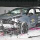 Frontal crash test of a Lynk & Co 02 electric SUV conducted by Euro NCAP, showing significant damage to the front end and deployed airbags inside the cabin.