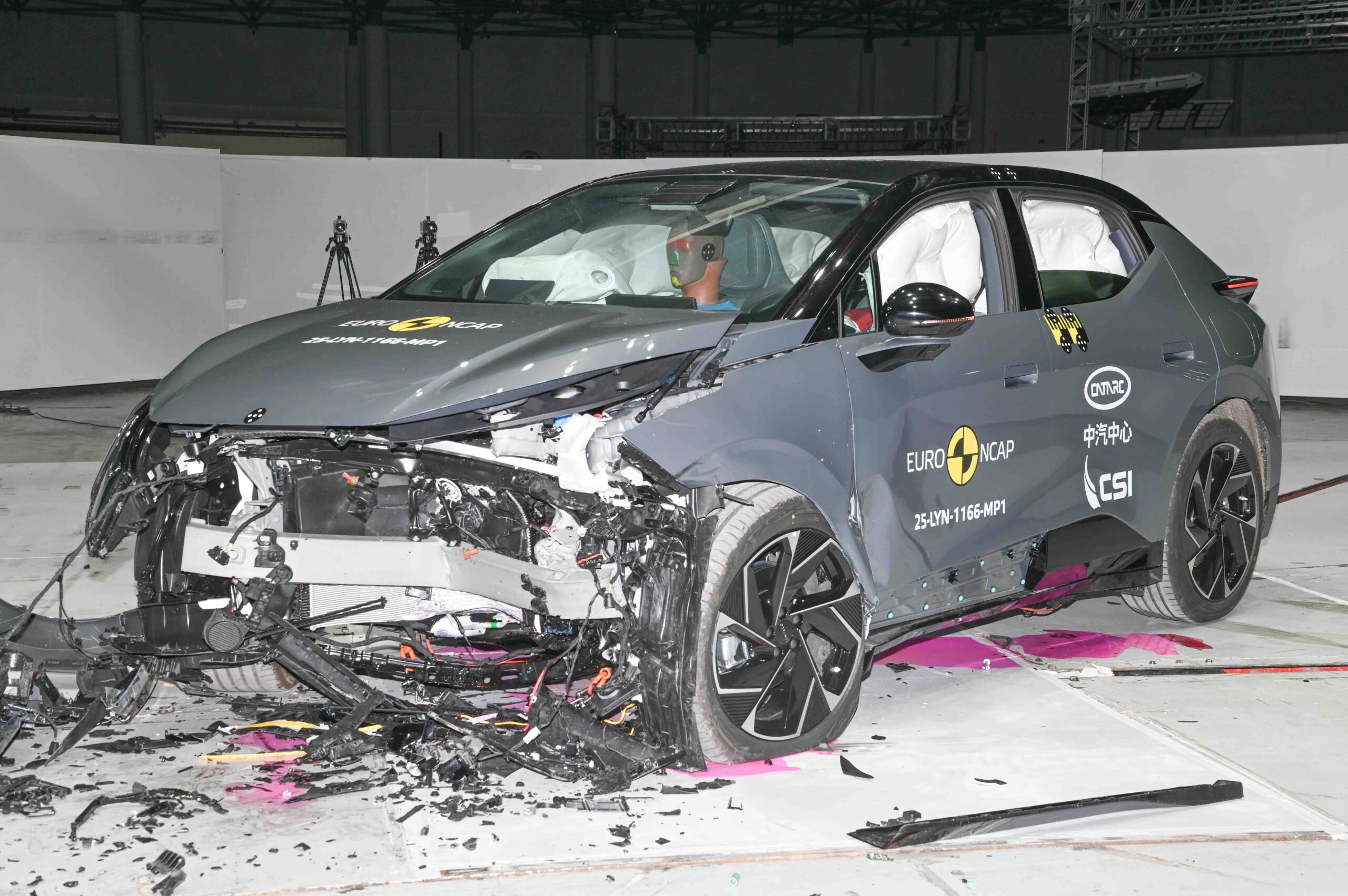 Frontal crash test of a Lynk & Co 02 electric SUV conducted by Euro NCAP, showing significant damage to the front end and deployed airbags inside the cabin.
