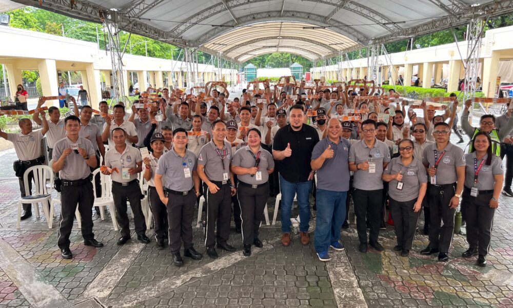 Group of Quezon City traffic enforcers and MDPPA representatives pose together during a road safety seminar under a covered outdoor venue.