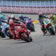 Marc Marquez leads the MotoGP pack into a turn at Sachsenring during the 2025 German Grand Prix, with riders closely trailing behind.