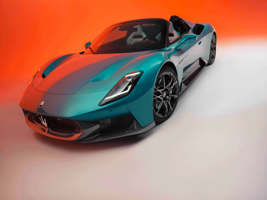 Maserati MCPURA Cielo in Ai Aqua Rainbow color against a vivid orange gradient background