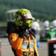 Lando Norris celebrates pole position in his McLaren race suit and helmet at Spa-Francorchamps