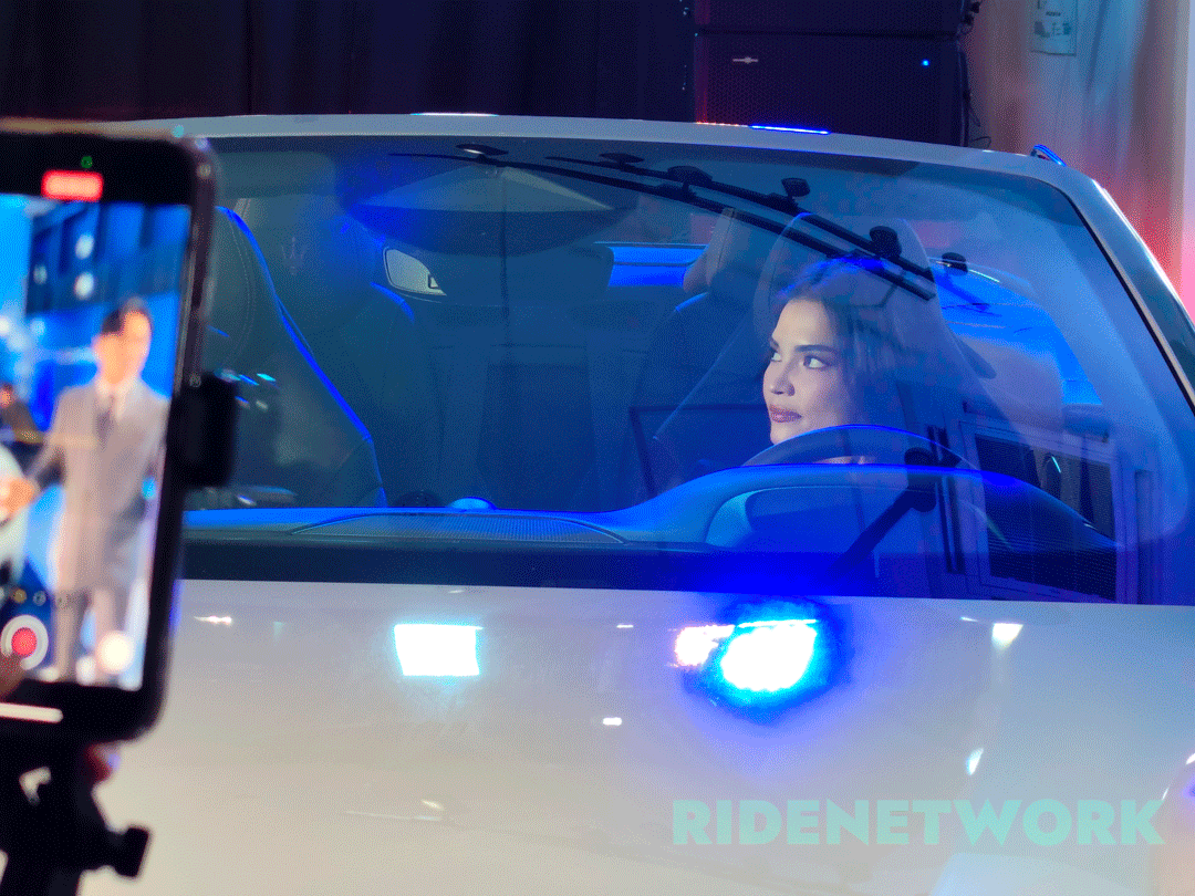 Actress Rhian Ramos sits inside the Maserati GranCabrio Folgore during its Philippine launch, illuminated by ambient blue lighting as an event livestream is captured on a nearby phone screen.