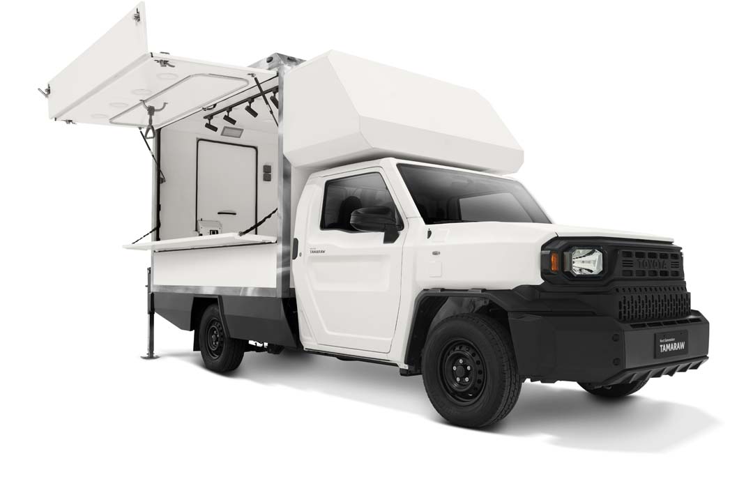 Side view of a white Toyota Tamaraw Mobile Store variant with its canopy doors open, revealing a compact interior fitted for mobile retail use.