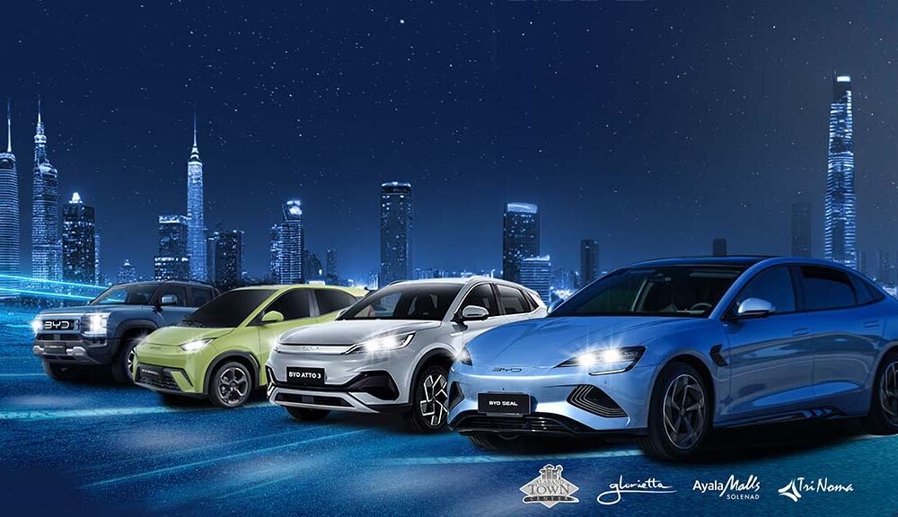 Four BYD electric vehicles—the Shark 6, Seagull, Atto 3, and Seal 5—parked in front of a futuristic city skyline at night, with Ayala Malls logos beneath them.