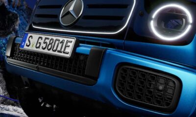 Close-up of the front grille and LED headlights of a blue Mercedes-Benz G 580 EQ, highlighting its modern electric design.