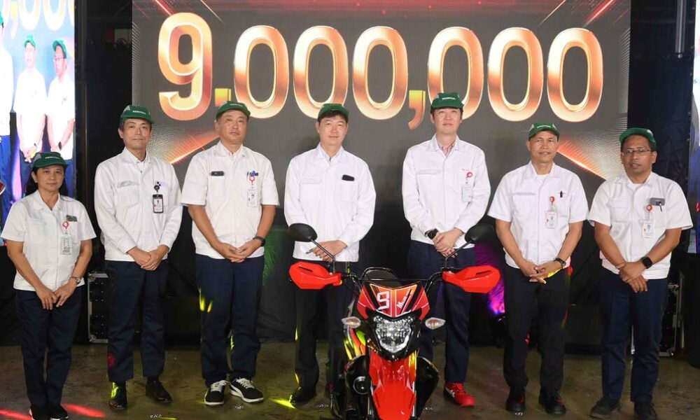 Executives of Honda Philippines, Inc. stand beside the commemorative 9 millionth unit motorcycle, the XRM125 DS, during the HPI Production Milestone Ceremony in Batangas.