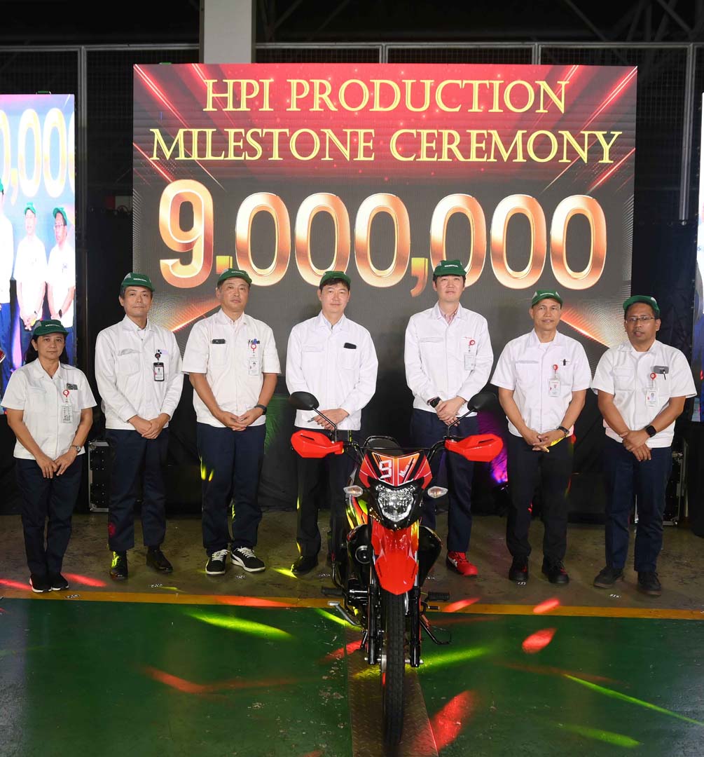 Executives of Honda Philippines, Inc. stand beside the commemorative 9 millionth unit motorcycle, the XRM125 DS, during the HPI Production Milestone Ceremony in Batangas.
