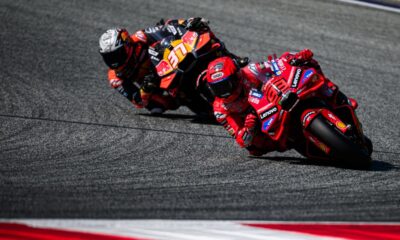 Marc Marquez leads a rival through a sharp corner during MotoGP practice at the Red Bull Ring in Austria.