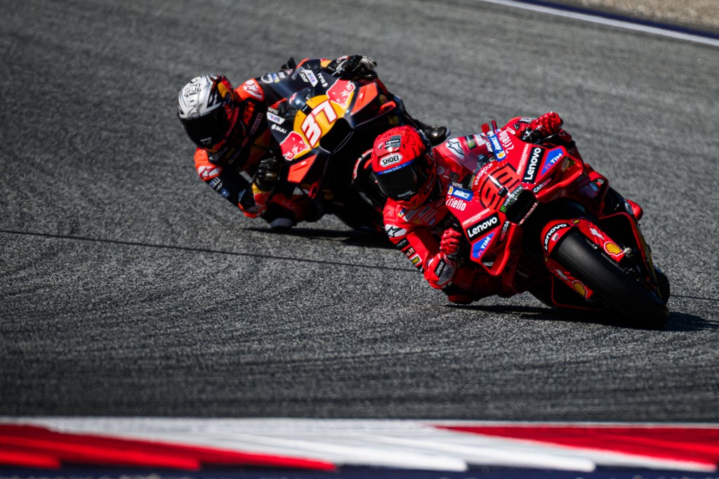 Marc Marquez leads a rival through a sharp corner during MotoGP practice at the Red Bull Ring in Austria.