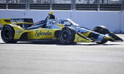 Christian Rasmussen driving the yellow-and-black Ed Carpenter Racing IndyCar at speed during the Milwaukee Mile 250.