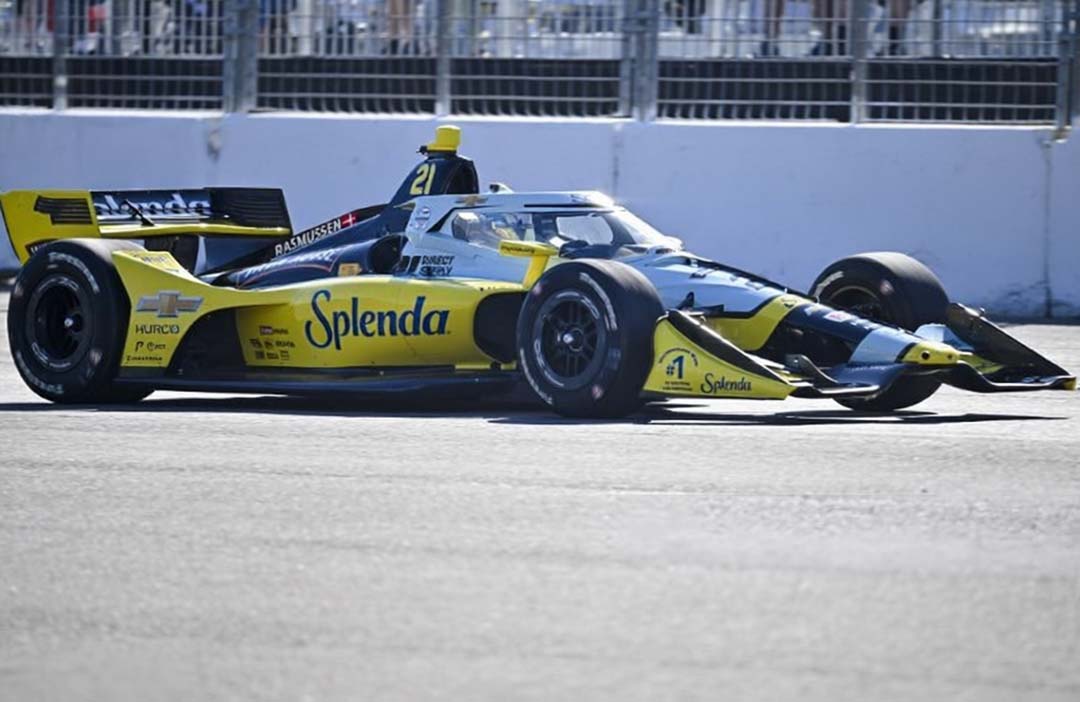 Christian Rasmussen driving the yellow-and-black Ed Carpenter Racing IndyCar at speed during the Milwaukee Mile 250.