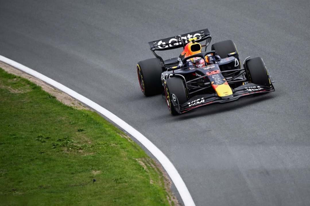 A Formula One car speeds through a corner at Zandvoort during Dutch Grand Prix weekend.