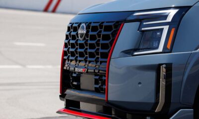 Close-up of the 2026 Nissan Armada NISMO front grille and headlight with red trim accents.