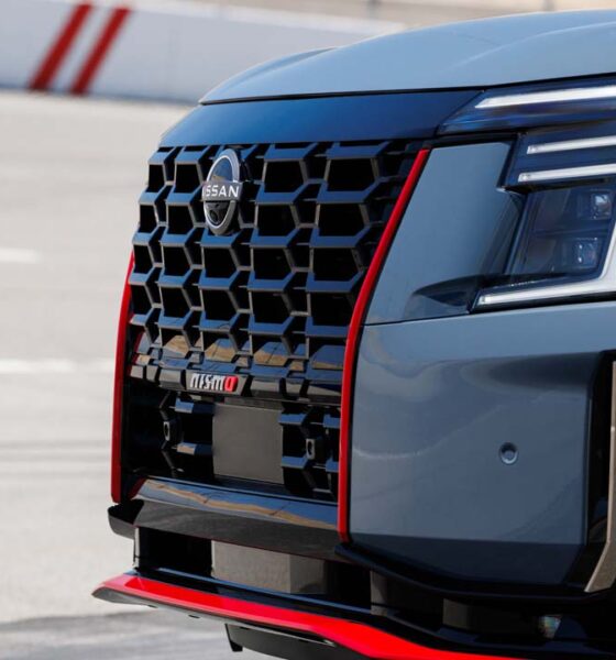 Close-up of the 2026 Nissan Armada NISMO front grille and headlight with red trim accents.