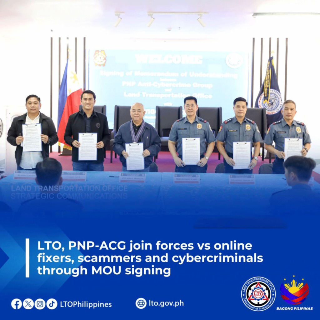 Officials from the Land Transportation Office (LTO) and the Philippine National Police Anti-Cybercrime Group (PNP-ACG) hold signed documents during the MOU signing ceremony against online fixers, scammers, and cybercriminals.