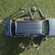 Aerial view of an Isuzu mu-X parked on grass with passengers opening the doors, ready for an outdoor trip.