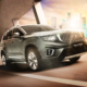 A Geely Okavango Elite SUV driving on an urban road with the city skyline in the background.
