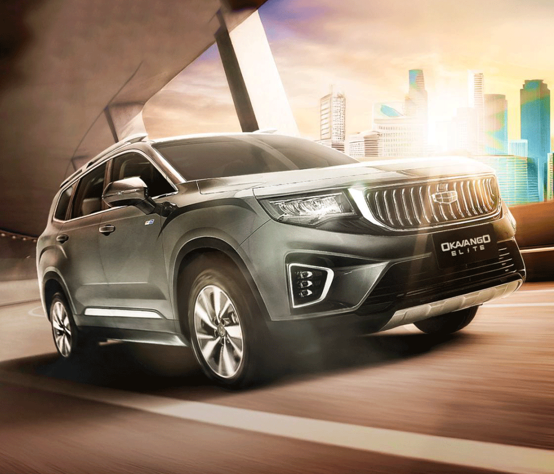 A Geely Okavango Elite SUV driving on an urban road with the city skyline in the background.