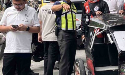 Quezon City traffic and safety officials inspect a damaged tricycle during a road clearing operation along G. Araneta Avenue.