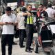 Quezon City traffic and safety officials inspect a damaged tricycle during a road clearing operation along G. Araneta Avenue.