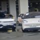 A lineup of electric vehicles, including a BYD crossover and a Wuling compact EV, parked in an urban lot during a Philippine EV industry event.
