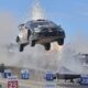 Sebastien Ogier’s Toyota Yaris Rally1 car airborne during a jump at the Rally of Chile, with sparks flying and the Chilean flag in the background.
