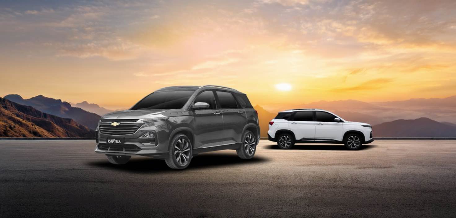 Two Chevrolet Captiva SUVs, one in black and one in white, displayed on a scenic mountain road at sunset with the text "Captivate Your Drive" and the BPI partner logo.