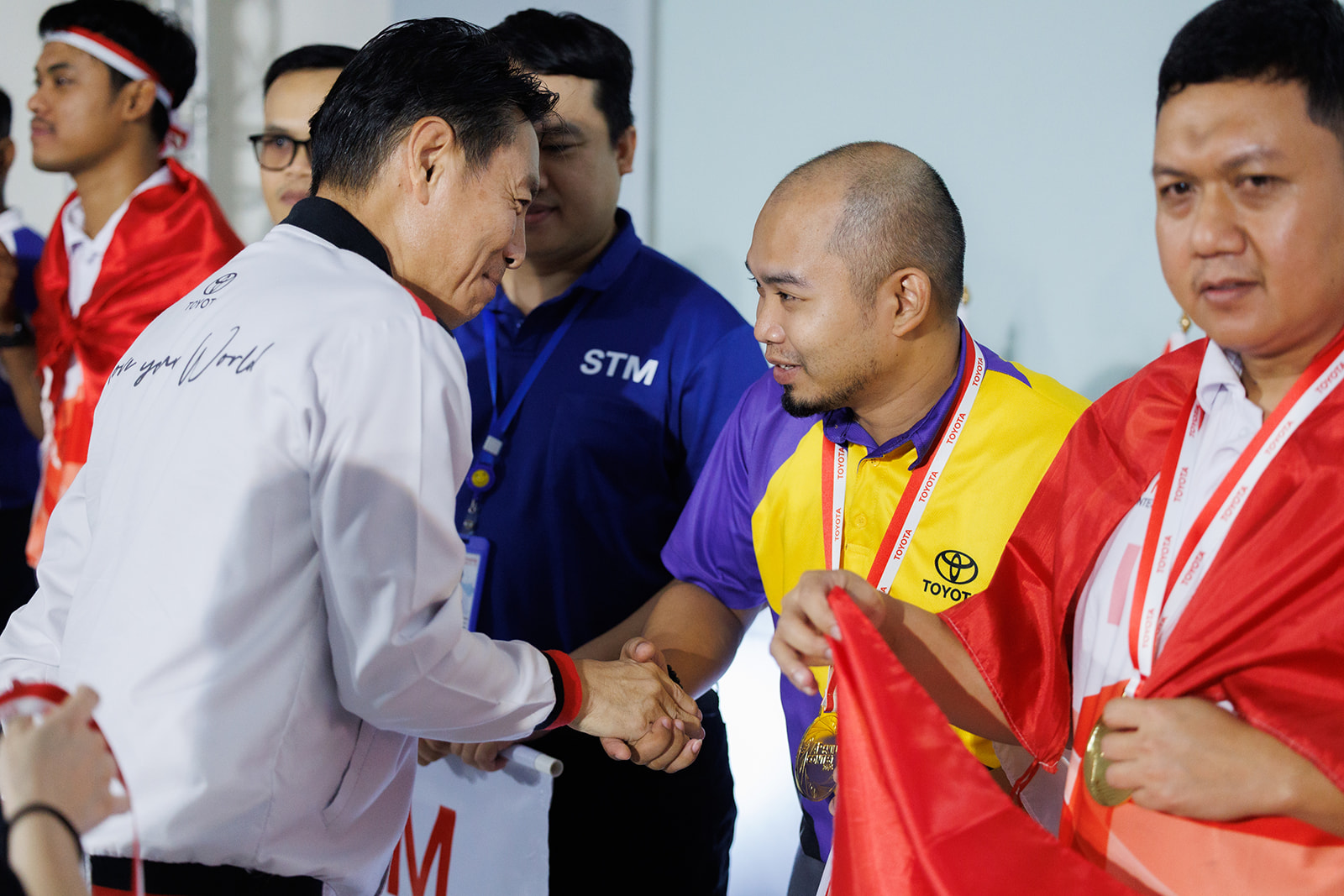 Eduardo Lazo Jr. of Toyota Motor Philippines receives congratulations after winning gold at the 2025 Toyota Asia Pacific Skills Contest in Thailand.