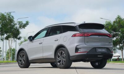 Rear view of the new BYD Tang DM-i plug-in hybrid SUV in silver, parked outdoors with trees and lamp posts in the background.