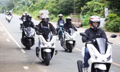 A group of riders on Honda PCX160 scooters cruise together along a countryside road in Tanay during the PCXceptional Ride event.