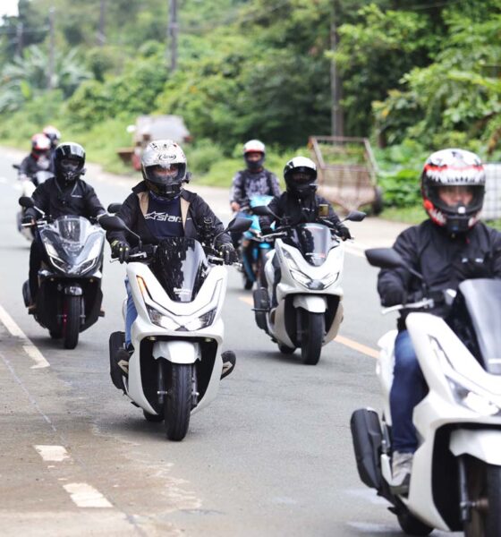 A group of riders on Honda PCX160 scooters cruise together along a countryside road in Tanay during the PCXceptional Ride event.