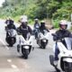A group of riders on Honda PCX160 scooters cruise together along a countryside road in Tanay during the PCXceptional Ride event.